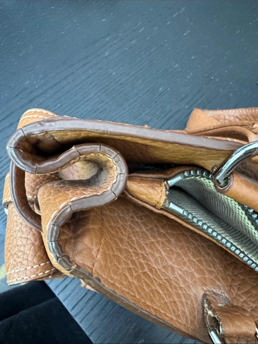 Dooney & Bourke tan pebbled leather side pockets belted satchel bag.